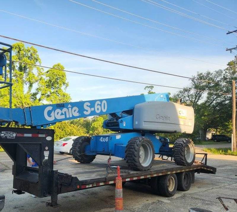 Genie S-60 boom lift on the gooseneck trailer after a tree job in Slidell